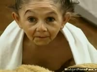 Dwarf joins pair of stunning babes as they enjoy oral sex on bed before being joined by dude